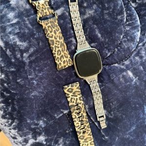 Fitbit Versa 3 w/ a charger and 2 bands size small/med